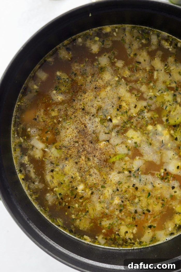 Bright Lemon Rosemary Chicken Noodle Soup 13 Seasoning the Lemon Rosemary Chicken Noodle Soup with salt and pepper