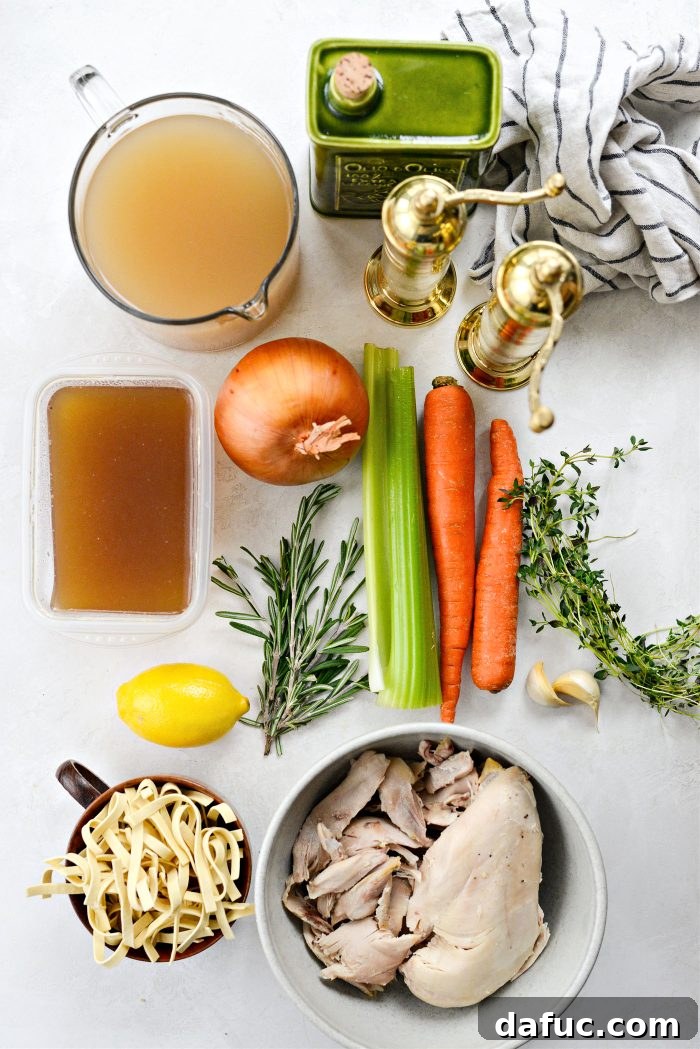Bright Lemon Rosemary Chicken Noodle Soup 4 Fresh ingredients for Lemon Rosemary Chicken Noodle Soup laid out on a cutting board