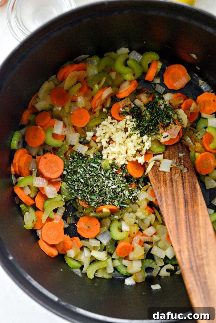 Bright Lemon Rosemary Chicken Noodle Soup 8 Adding minced garlic, fresh rosemary, and fresh thyme to softened vegetables