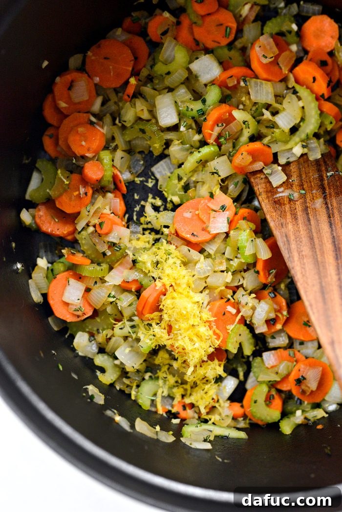 Bright Lemon Rosemary Chicken Noodle Soup 9 Grating lemon zest into the soup base