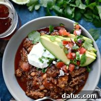 A vibrant bowl of Ancho Chorizo Chili, garnished and ready to serve.