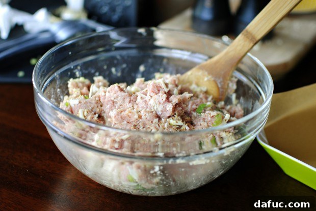 stir to combine Mixing turkey burger ingredients to combine