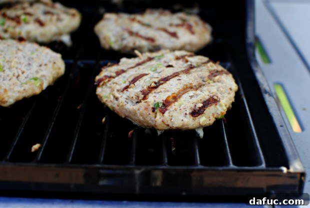 flip Flipping grilled turkey burgers on the grill
