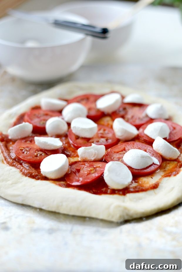 Pure Margherita Perfection 8 top with sliced tomatoes and mozzarella