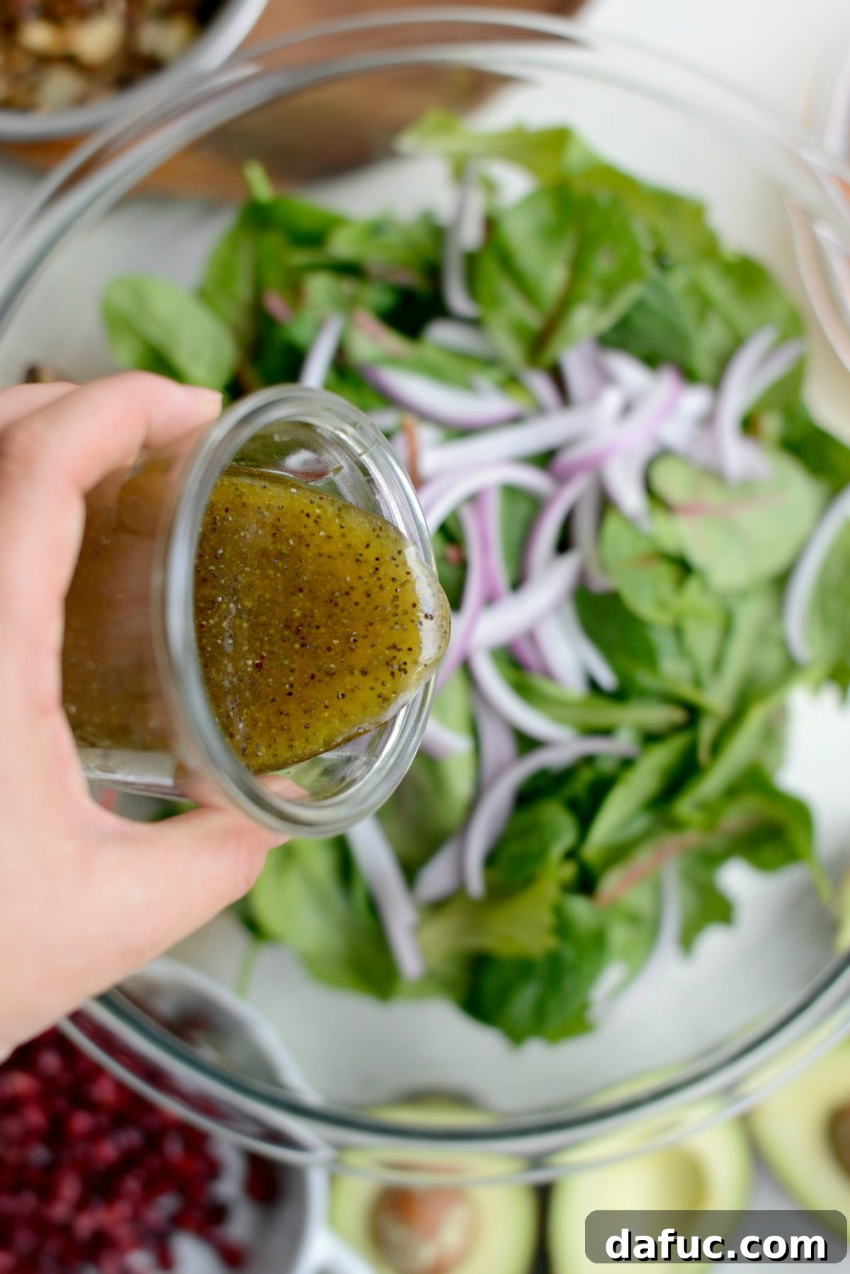 Golden Citrus Poppy Seed Salad 11 pour a little dressing over salad greens and onions