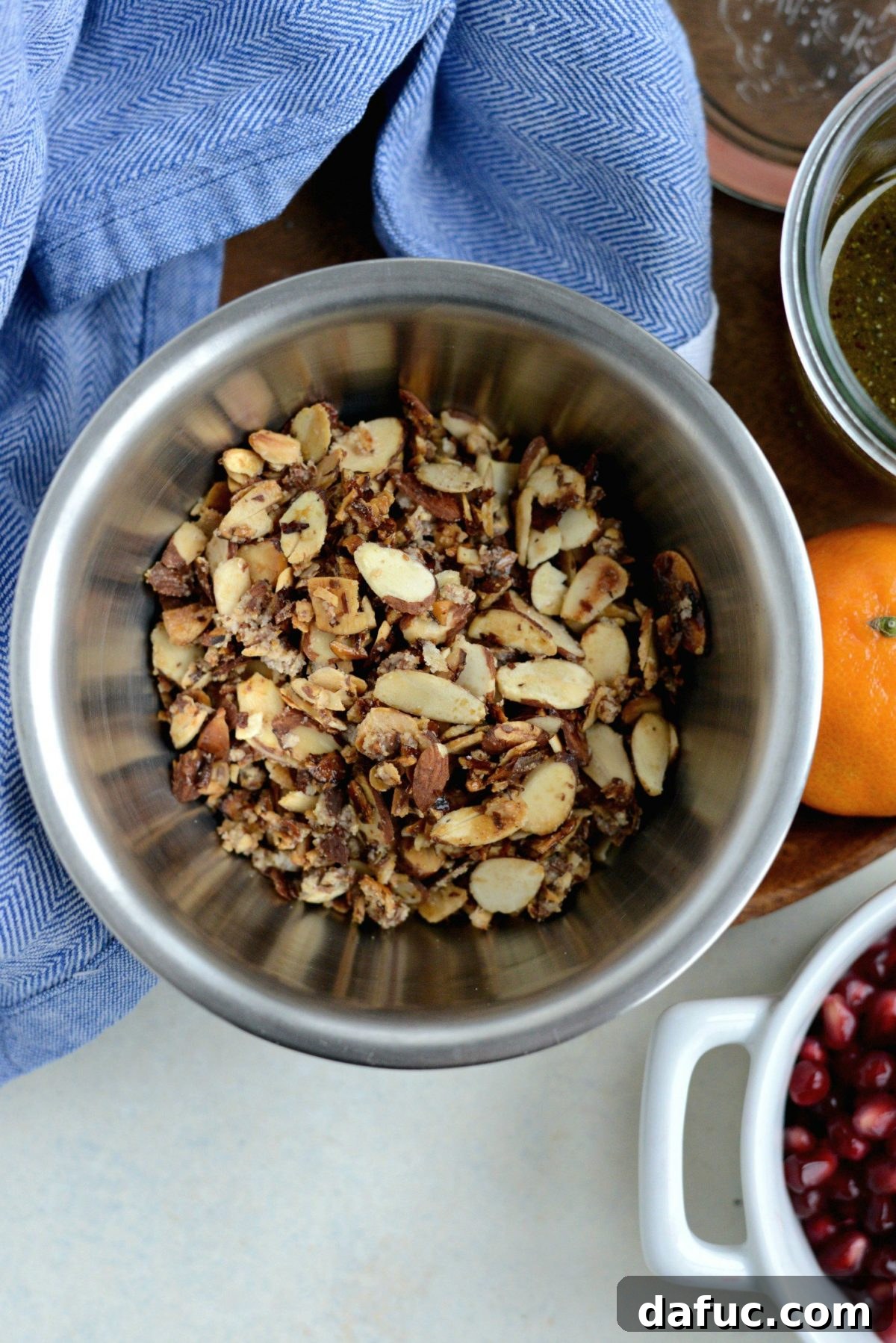 Golden Citrus Poppy Seed Salad 6 toasted candied almonds in bowl.