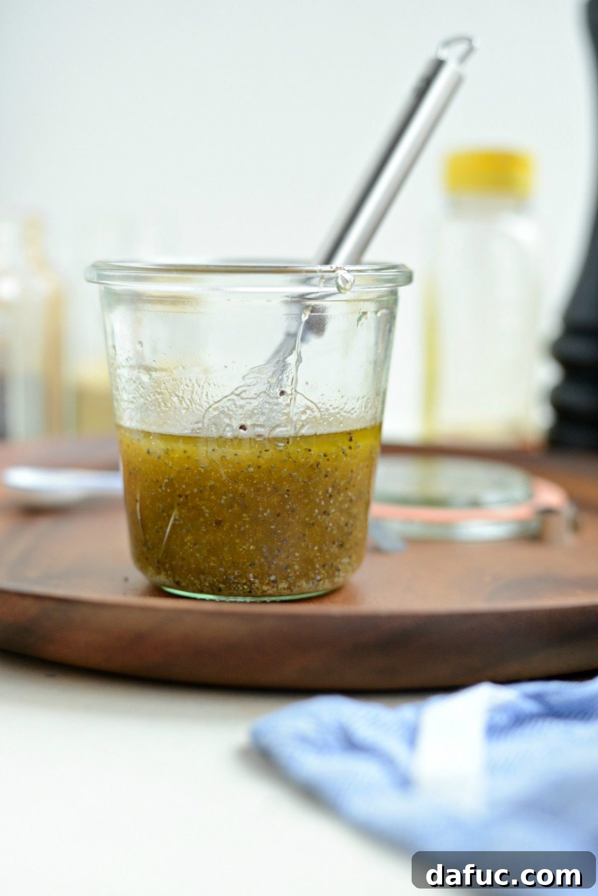 Golden Citrus Poppy Seed Salad 8 whisked vinaigrette in jar.