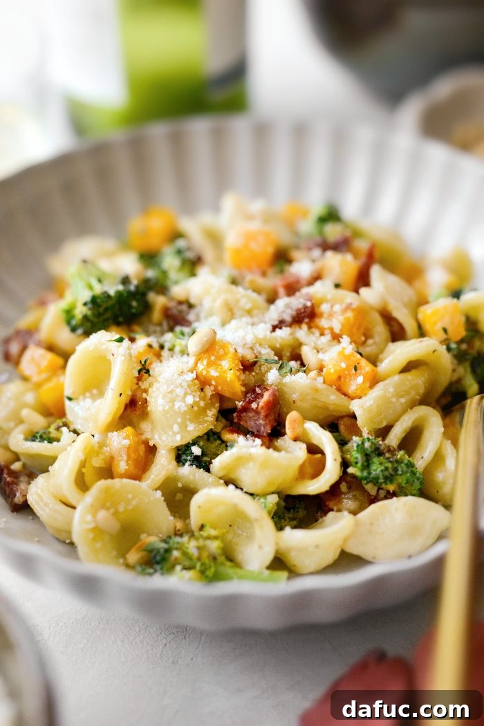 Autumn Orecchiette with Pancetta, Butternut Squash, and Broccoli 19 Orecchiette Pasta served in a white bowl with a fork, ready to eat