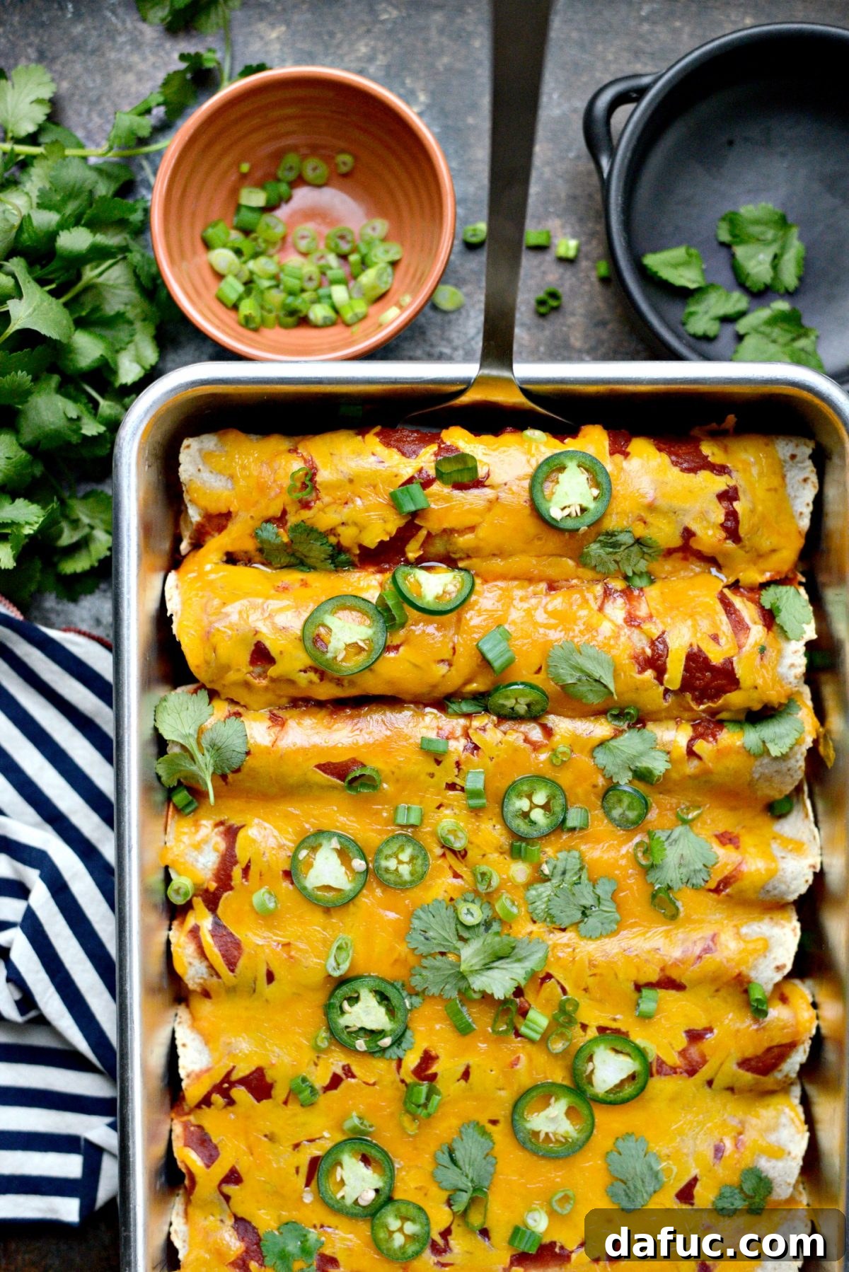 Fiesta Chicken and Rice Enchiladas 10 Baked Chicken and Rice Enchiladas garnished with fresh herbs