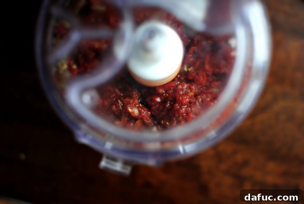 Food processor blending the roasted red pepper pizza sauce