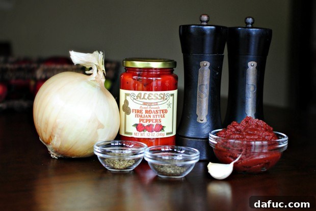 Close-up shot of creamy roasted red pepper pizza sauce in a white bowl
