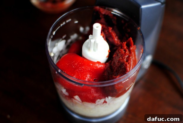 Tomato paste added to the food processor with other ingredients