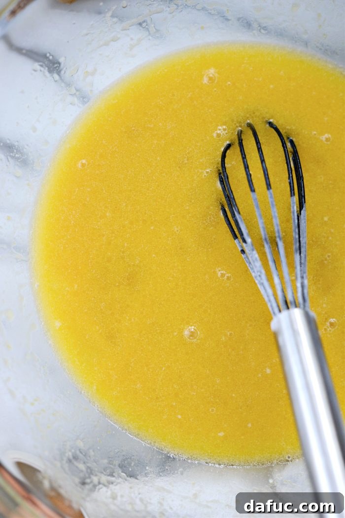 Irresistibly Easy Homemade Rolls 11 Wet ingredients (yeast, water, sugar, butter, eggs) being whisked together
