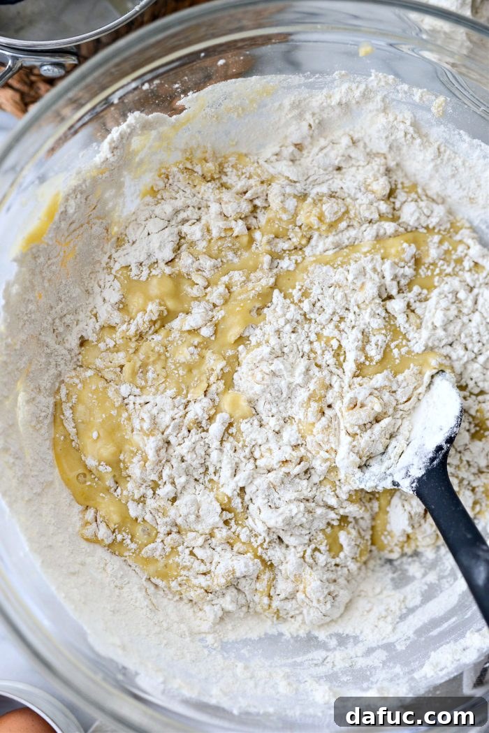 Irresistibly Easy Homemade Rolls 13 Stirring the flour mixture into the dough until combined