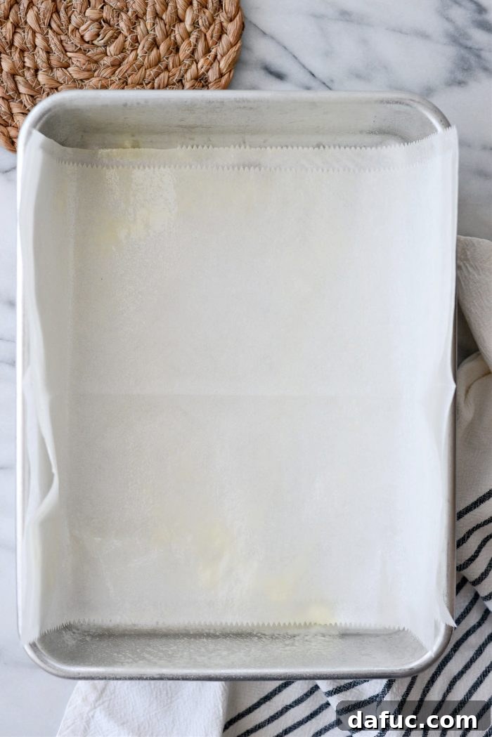 Irresistibly Easy Homemade Rolls 15 9x13 baking pan lined with parchment paper and greased