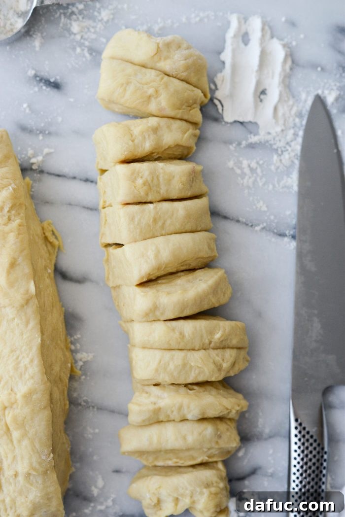 Irresistibly Easy Homemade Rolls 20 Dough pieces being cut from the log into uniform portions