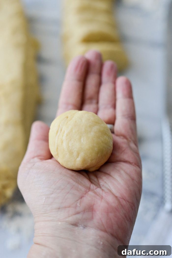 Irresistibly Easy Homemade Rolls 22 Rolling a piece of dough into a smooth ball between palms