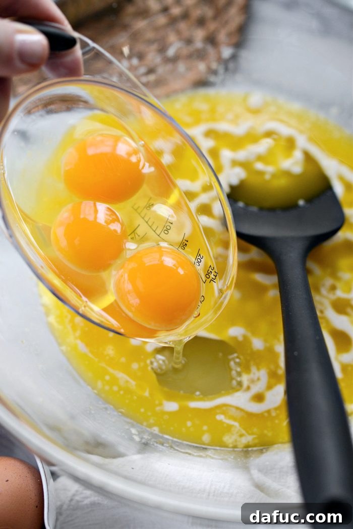 Irresistibly Easy Homemade Rolls 10 Three large eggs being added to the wet ingredient mixture