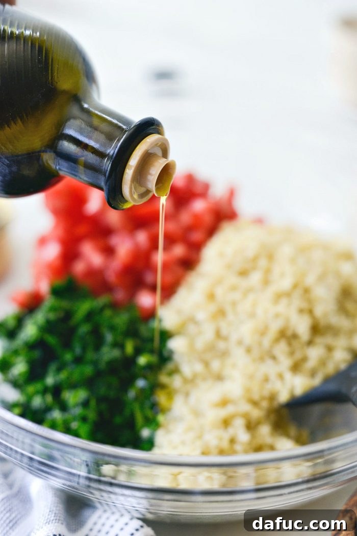 Garden Fresh Tabbouleh Delight 11 A stream of golden olive oil being poured into the tabbouleh mixture, illustrating the final dressing step.