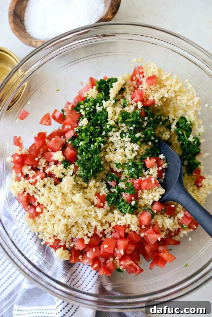 Perfect Homemade Tabbouleh 11 All the tabbouleh ingredients thoroughly mixed in a large bowl, showcasing its vibrant green color.