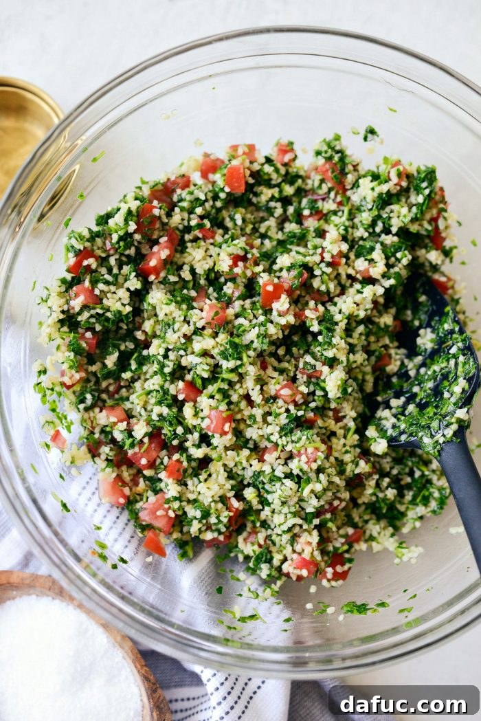 Garden Fresh Tabbouleh Delight 13 A close-up of the mixed tabbouleh, showing the vibrant colors of parsley, mint, tomatoes, and bulgur, ready for chilling.
