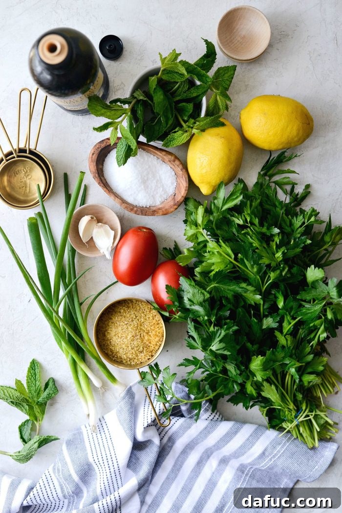 Perfect Homemade Tabbouleh 4 A close-up view of the raw ingredients for tabbouleh, showcasing fresh flat-leaf parsley, mint leaves, and green onions on a cutting board, ready for preparation.