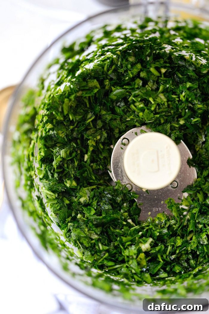 Perfect Homemade Tabbouleh 8 Fresh parsley, mint, green onions, and garlic being added to a food processor bowl, ready for mincing.