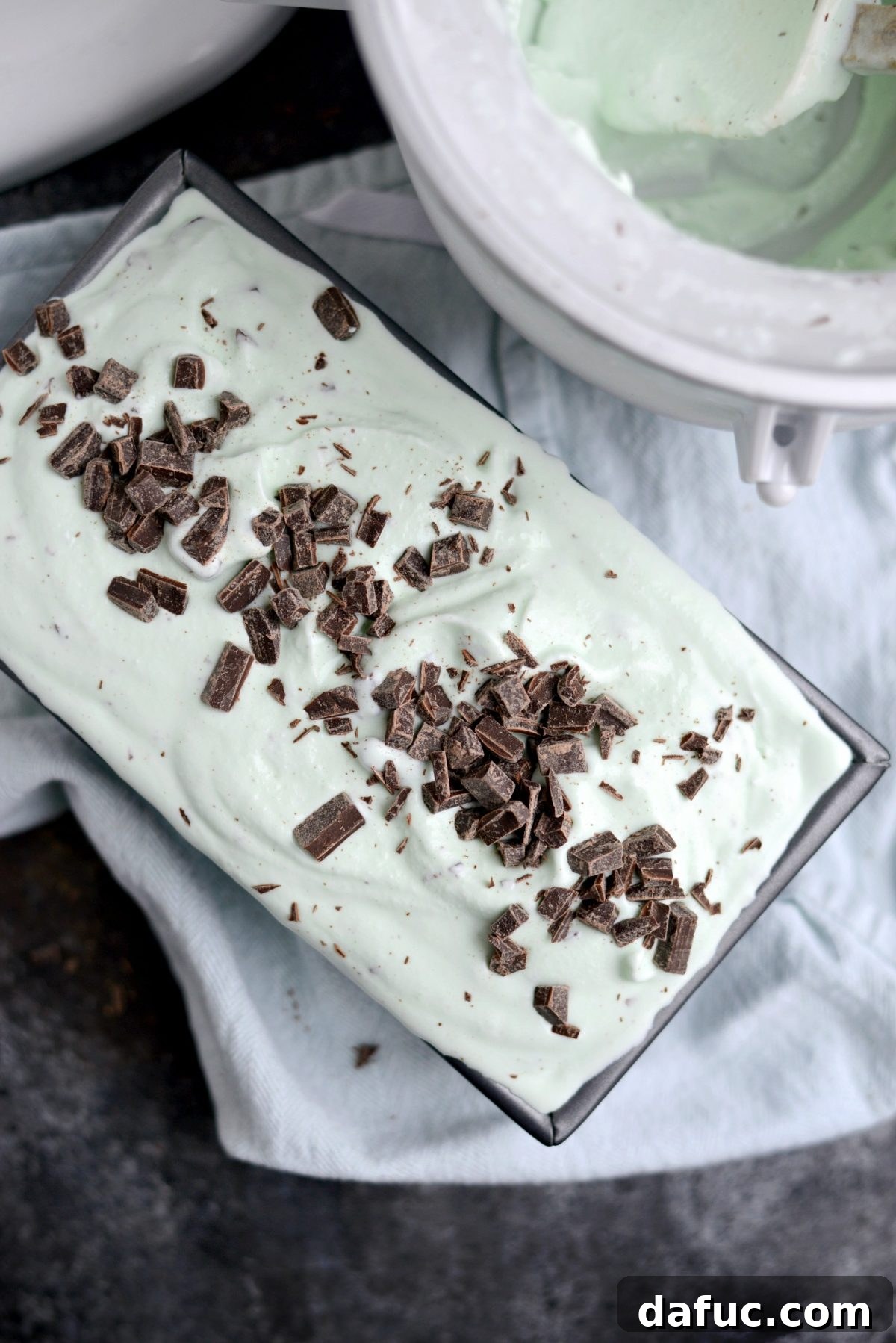 Transferring ice cream to freezer-safe container and topping with more chocolate