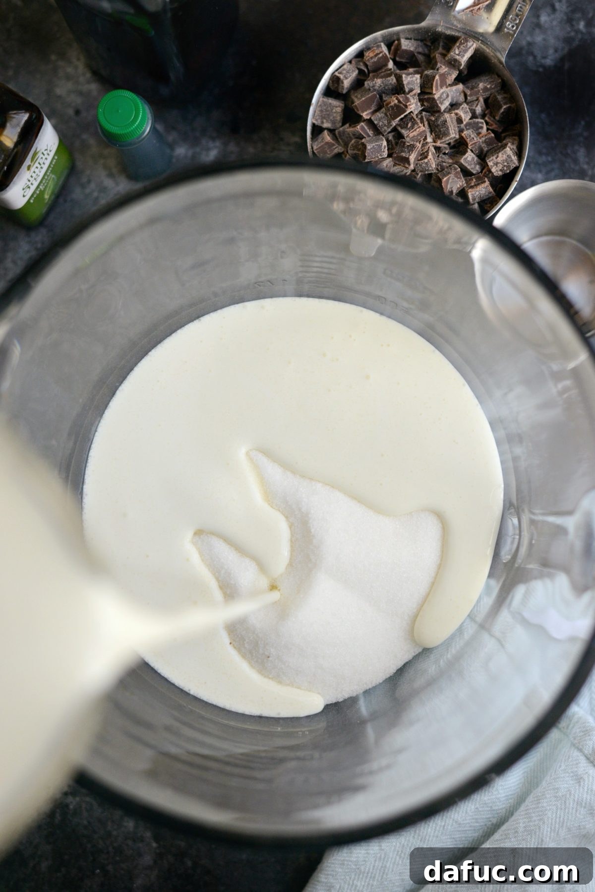 Sugar, salt, and heavy cream measured in a liquid measuring cup