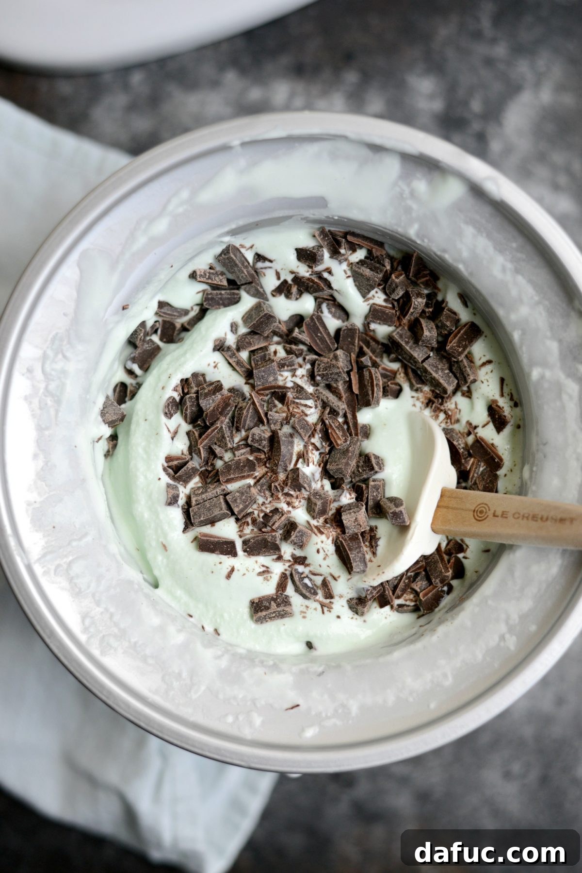 Adding chopped chocolate to churned ice cream
