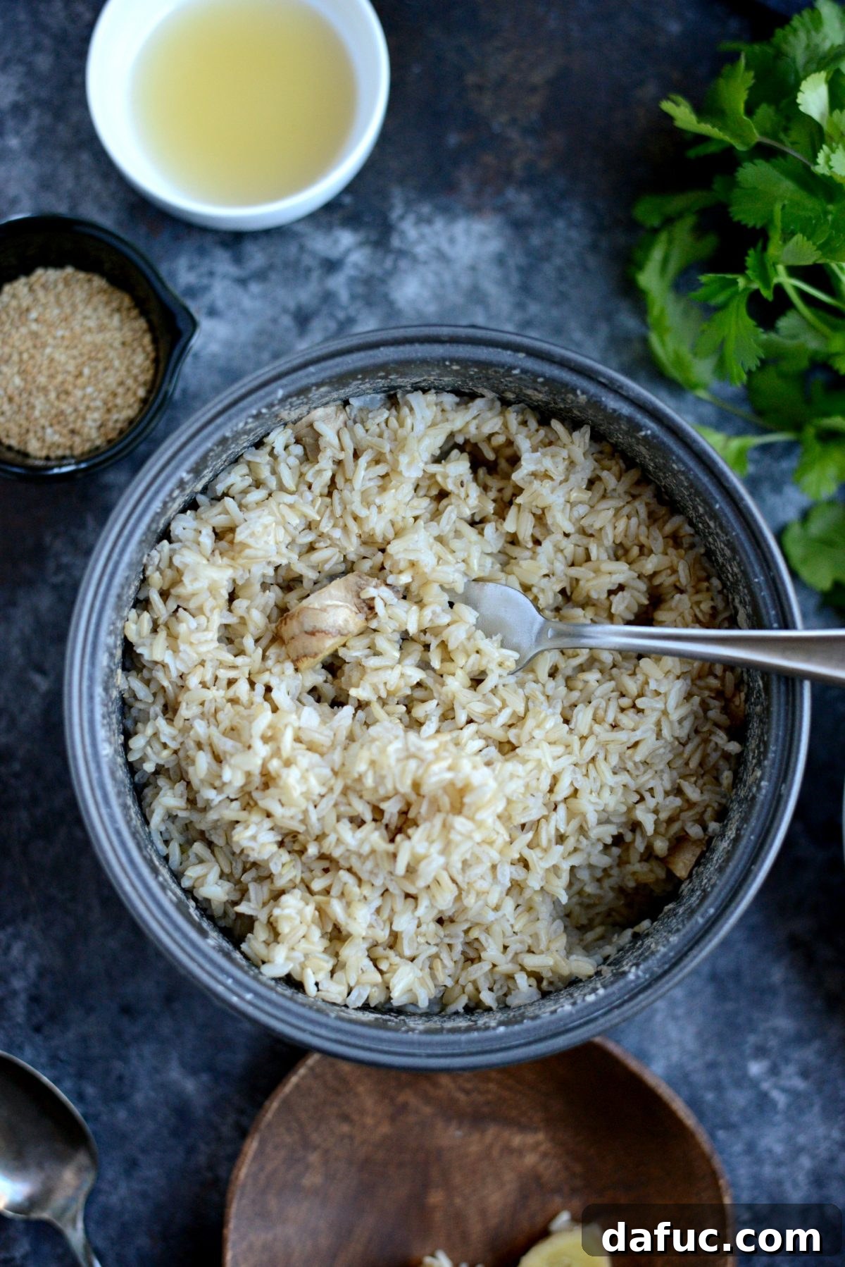 Toasted Sesame Ginger Brown Rice 8 Fluffing cooked brown rice with a fork and removing ginger pieces
