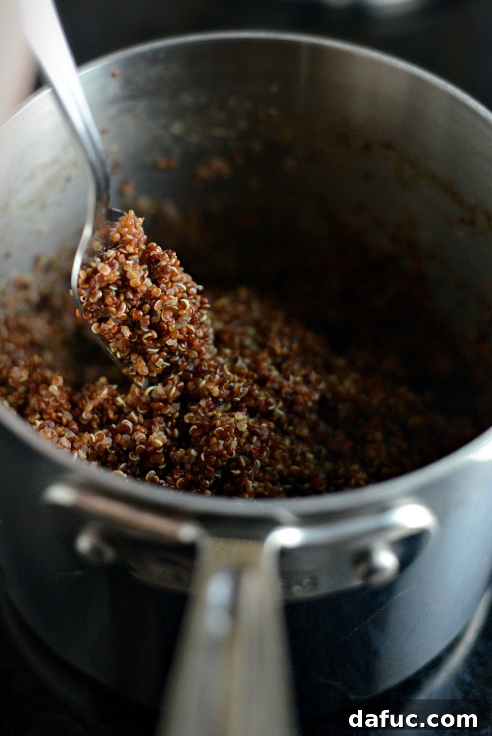 Foolproof Perfect Quinoa 10 Fluff cooked quinoa with a fork.