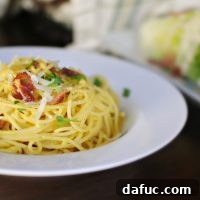 Spaghetti Carbonara dish with ingredients and garnishes