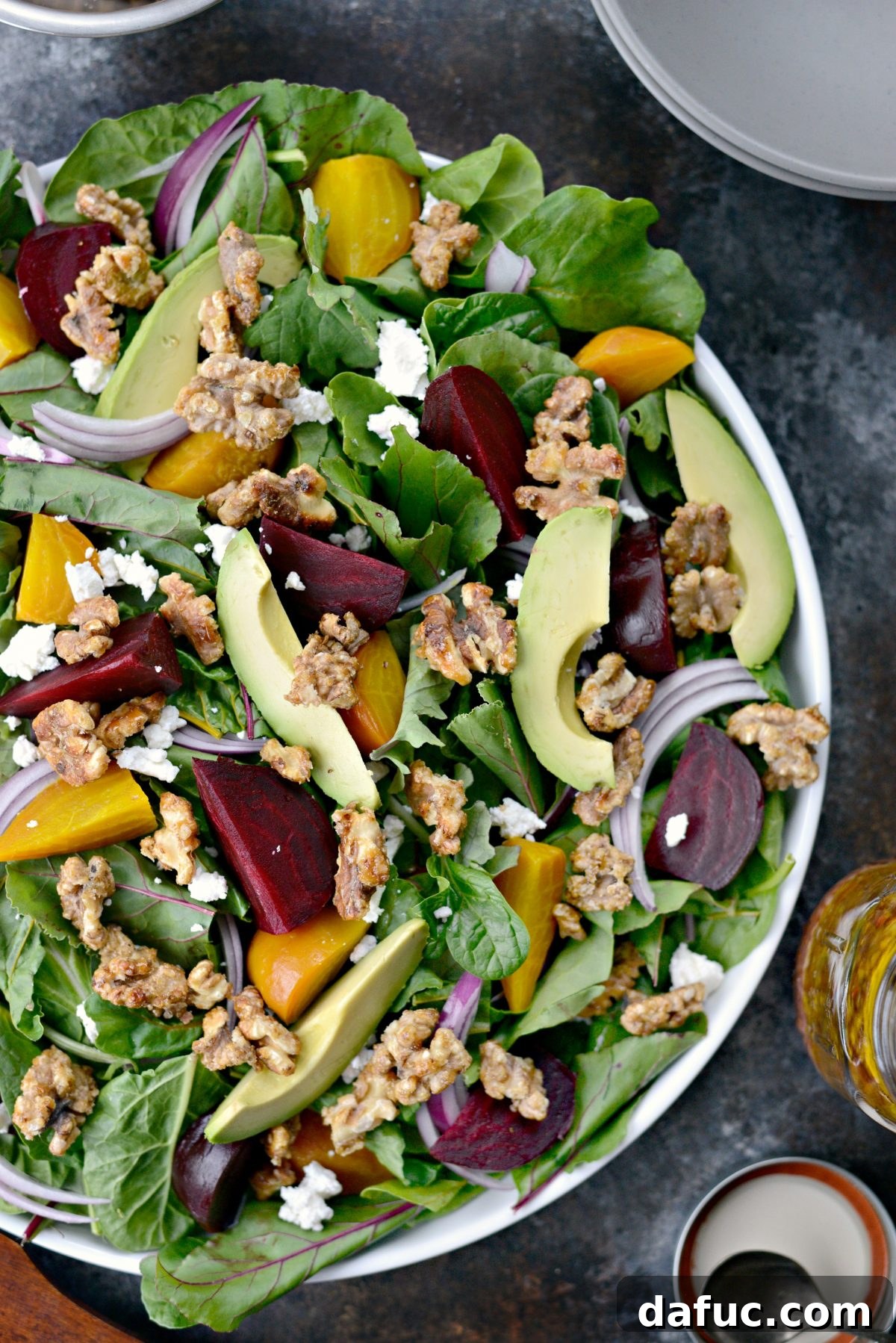 Honey-Kissed Roasted Beet Salad with Zesty Dijon 10 Assembling a fresh roasted beet salad on a platter