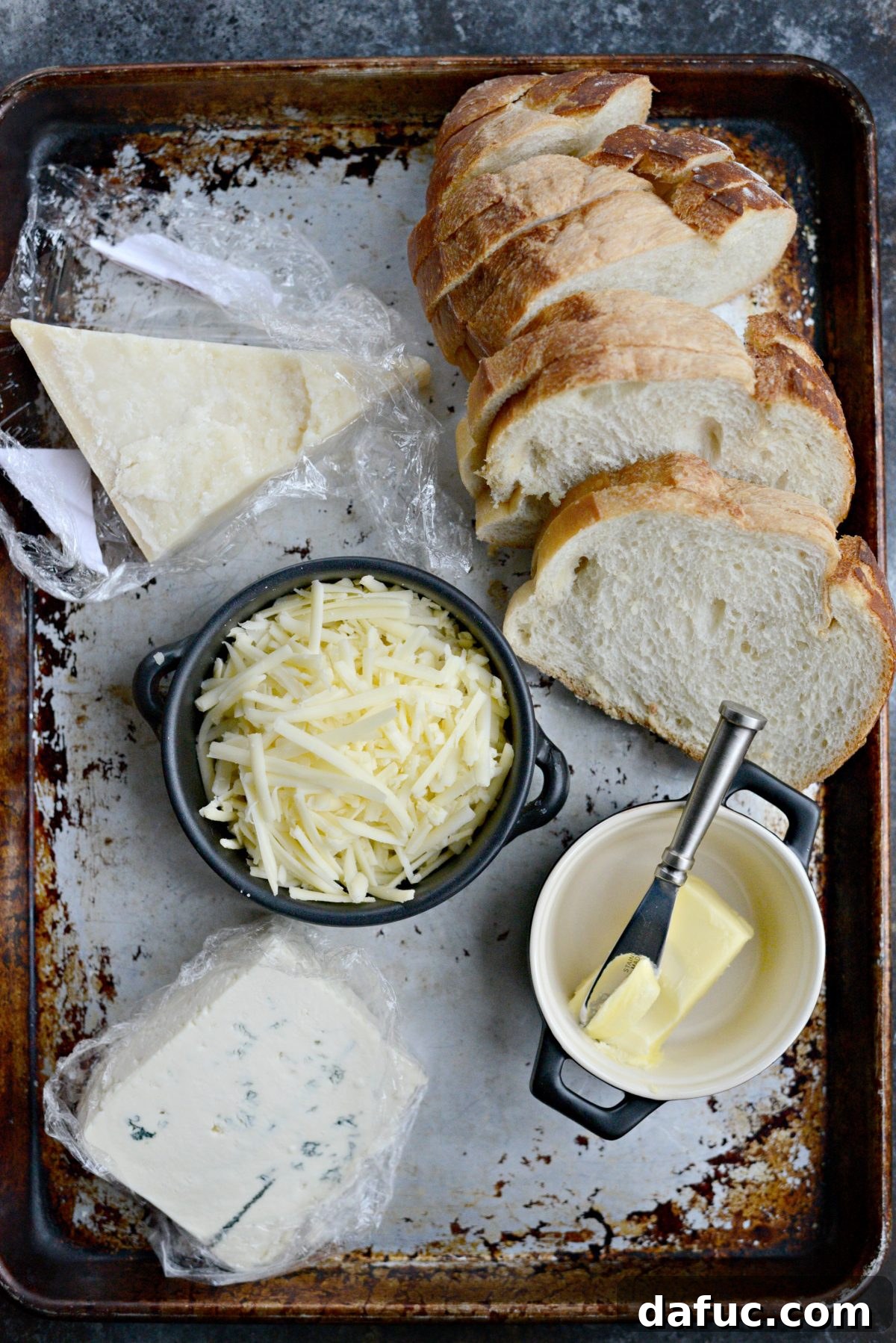 Ingredients for Fancy Three-Cheese Grilled Cheese Sandwich: Italian bread, butter, Vermont cheddar, Parmesan Reggiano, blue cheese