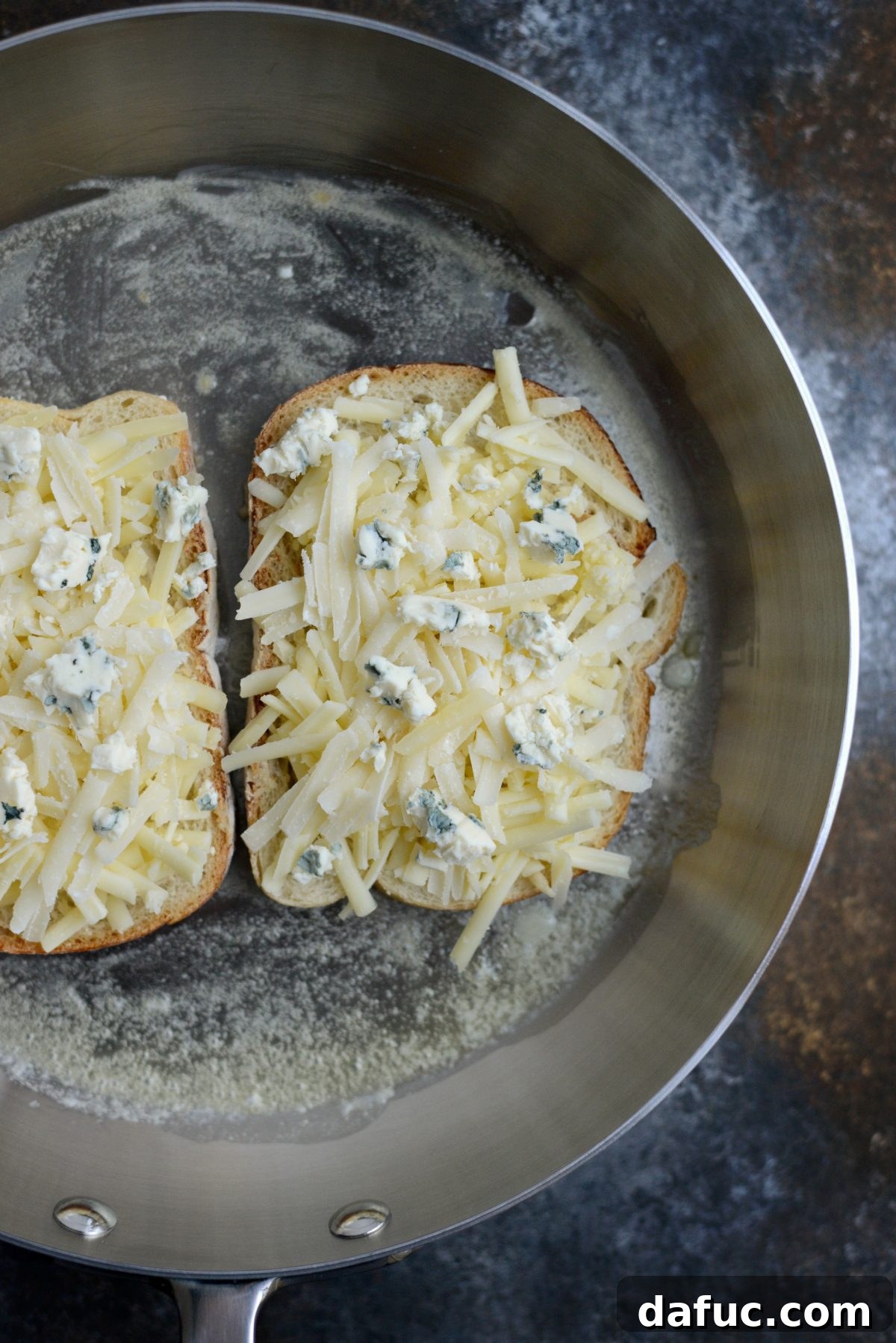 Cooking grilled cheese in a skillet with melting butter