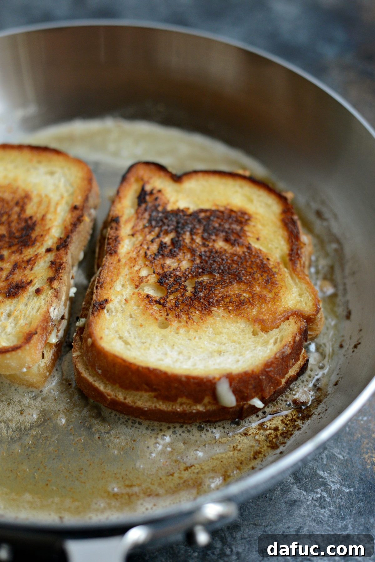 Flipping grilled cheese in a hot skillet