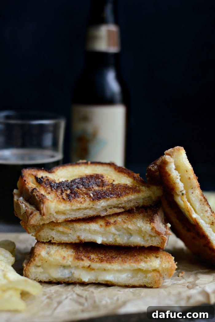 Fancy Three-Cheese Grilled Cheese Sandwich sliced and ready to eat
