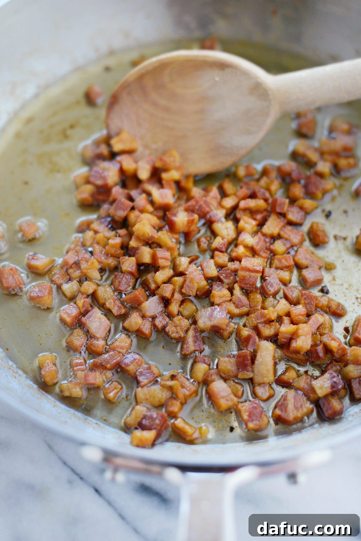 Spring Asparagus Pancetta Carbonara 5 Diced pancetta frying in a skillet for carbonara