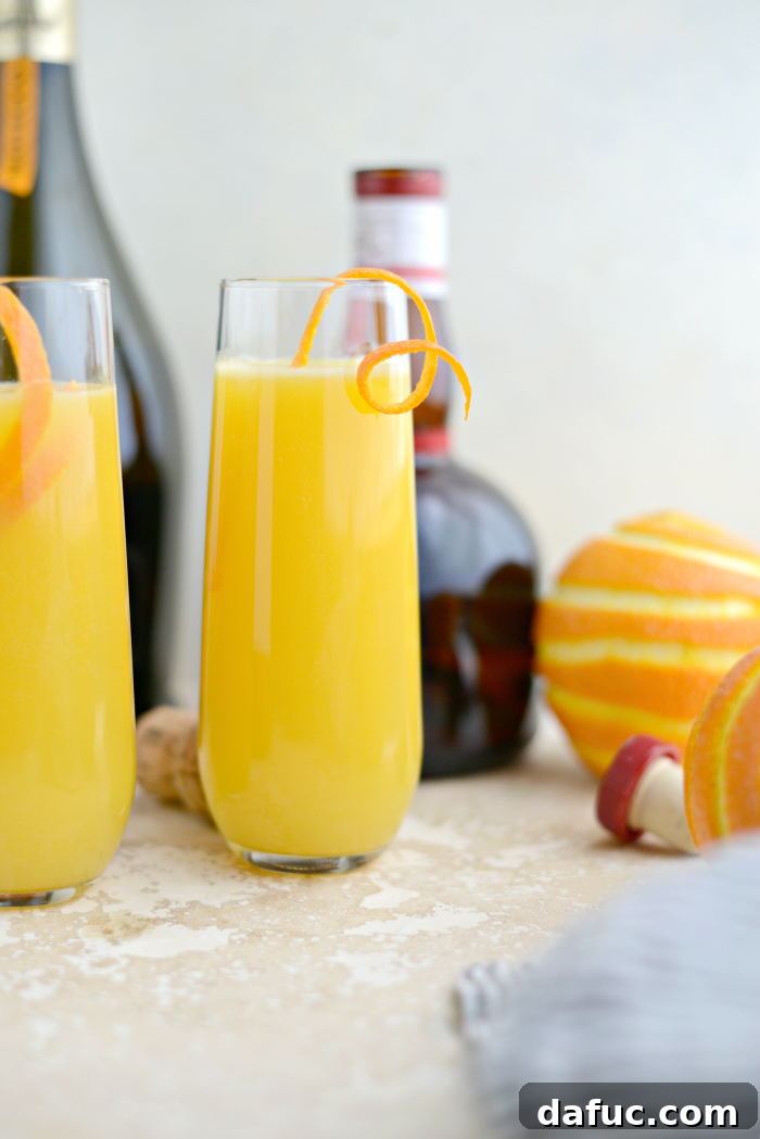 Classic Mimosa cocktail served in a flute glass, garnished with an orange peel