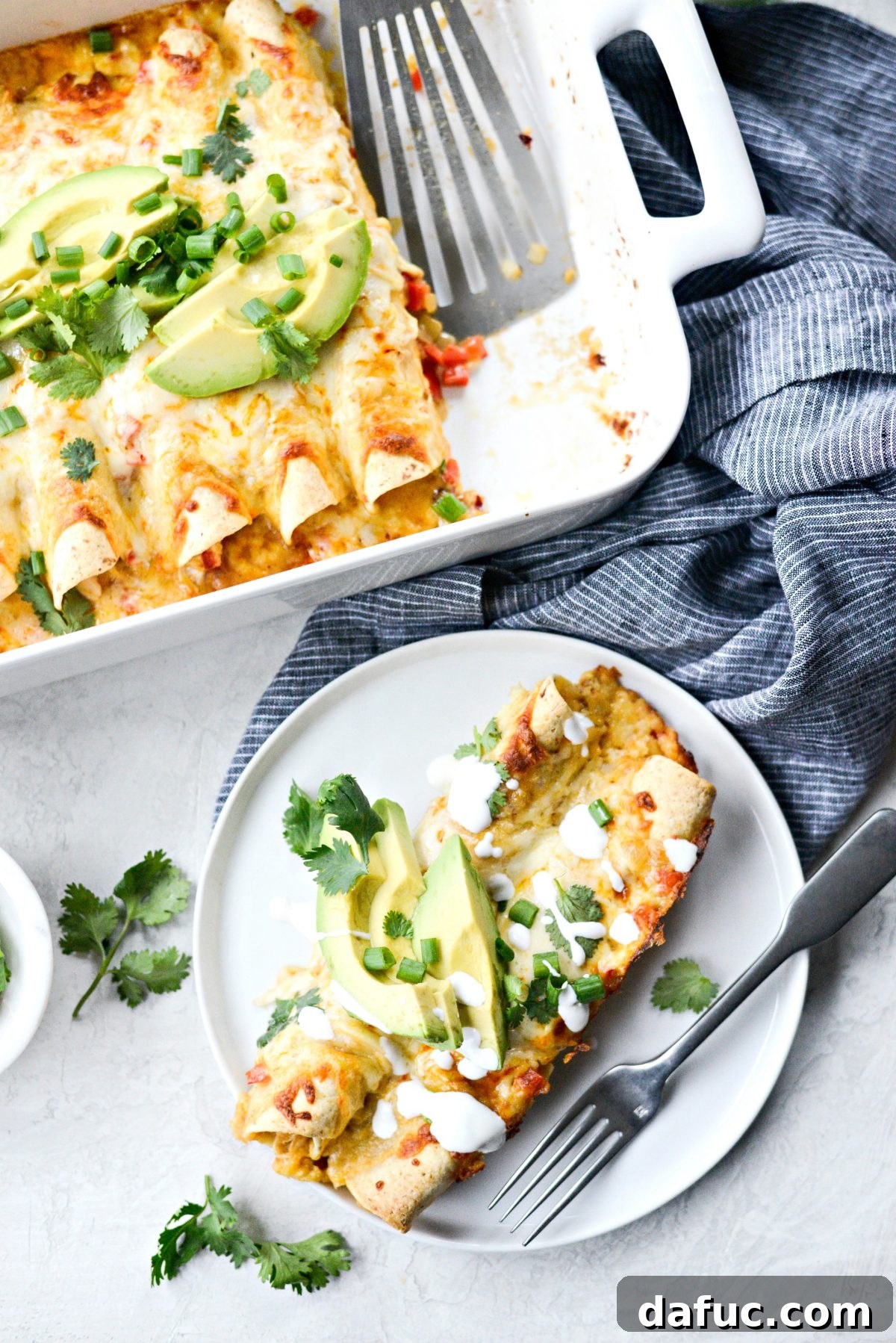 Close-up of a serving of Lighter Chicken Enchiladas, showing the creamy filling and melted cheese