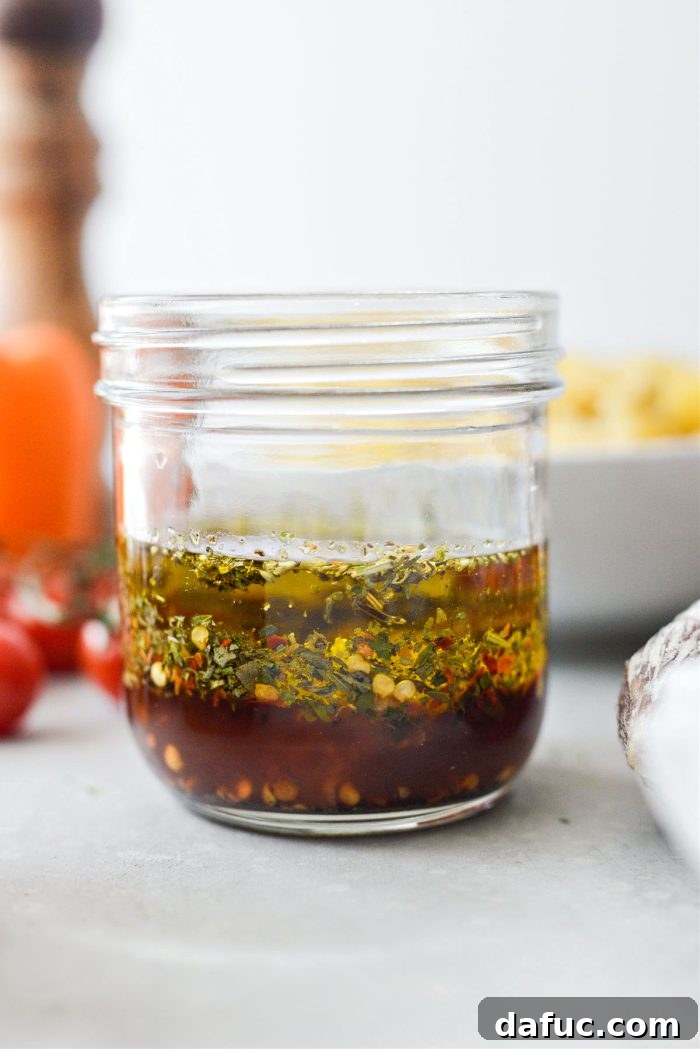 Mediterranean Bowtie Delight 5 Adding dressing ingredients to a jar
