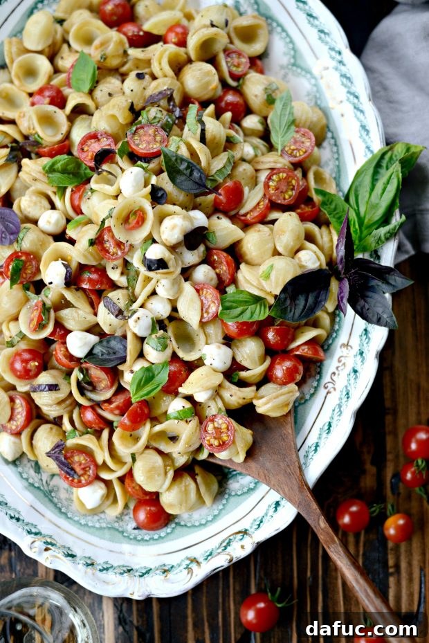 Caprese Pasta Salad with fresh mozzarella, tomatoes, and basil, tossed in balsamic vinaigrette.