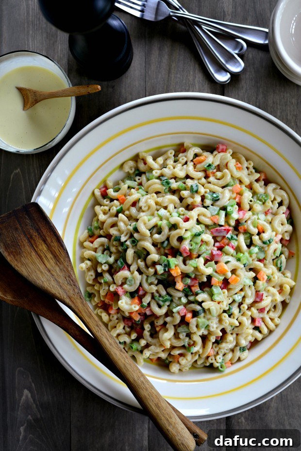 Classic Macaroni Salad with a rich, homemade dressing, featuring colorful vegetables.