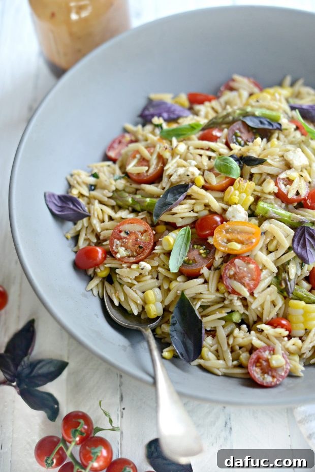 Asparagus, Tomato & Grilled Corn Orzo Pasta Salad, a colorful and fresh summer dish.