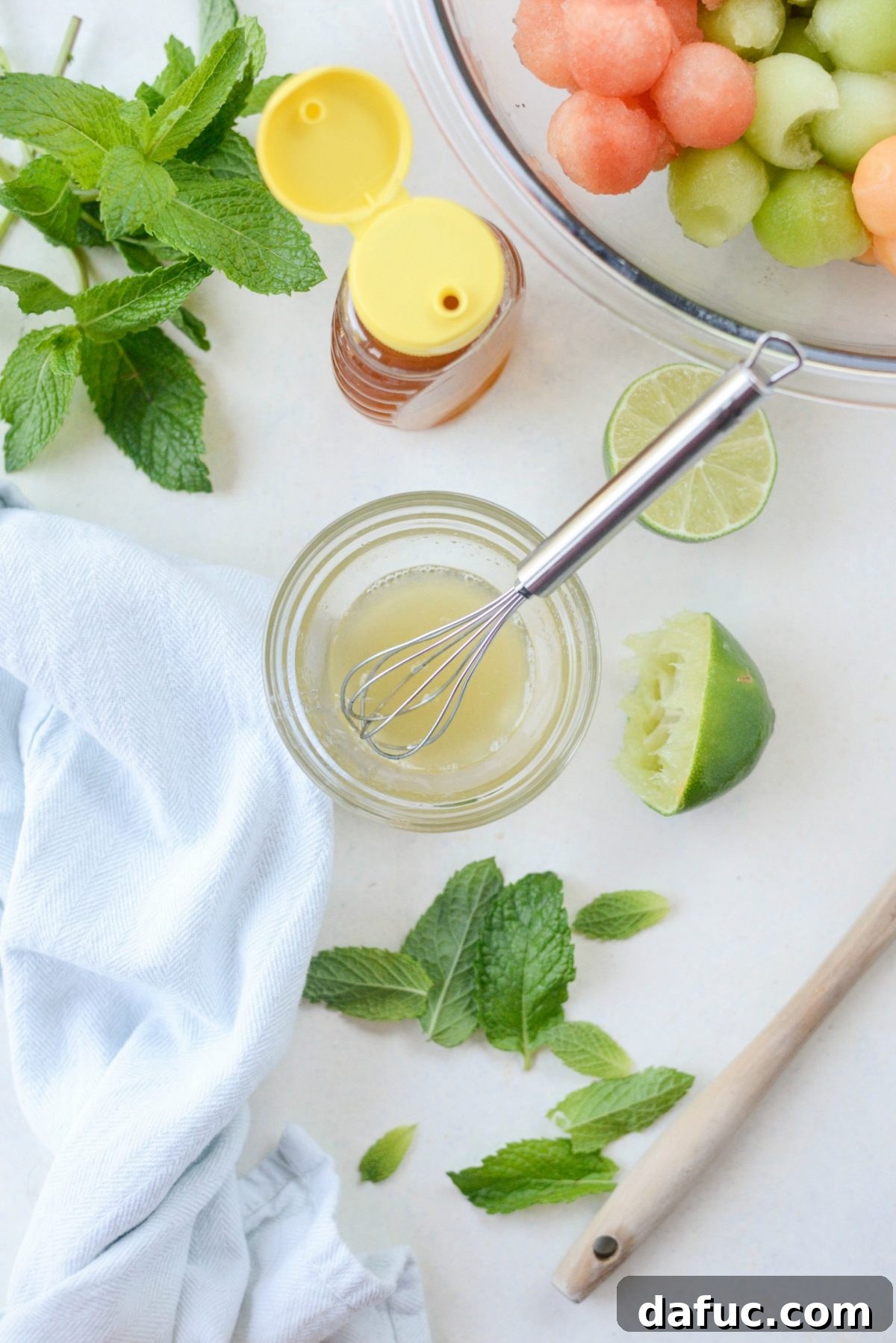 Honey Lime Mint Melon Delight 4 Ingredients for simple citrus honey dressing being prepared