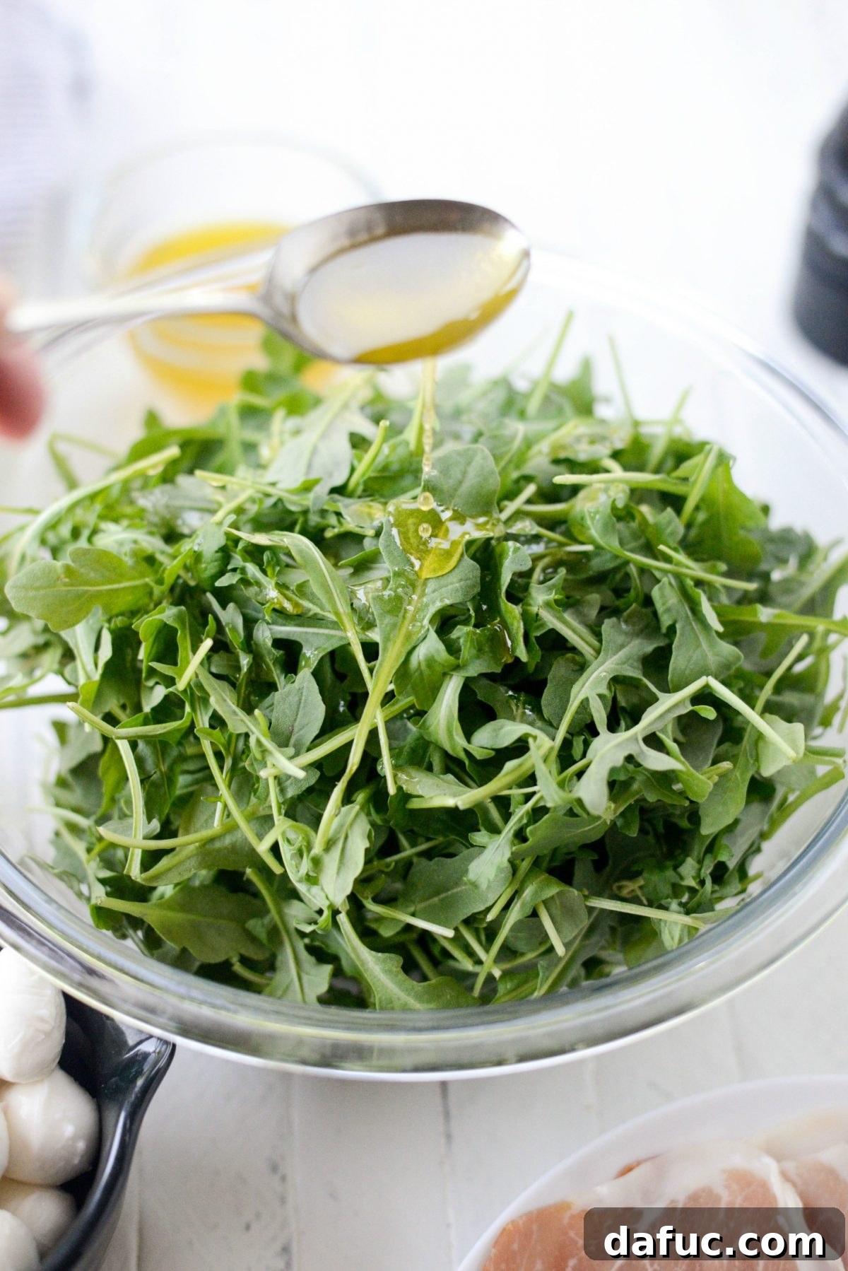 Golden Melon Prosciutto Arugula Fresca 5 Ingredients for Cantaloupe and Prosciutto Arugula Caprese Salad laid out, emphasizing fresh cantaloupe slices and mozzarella