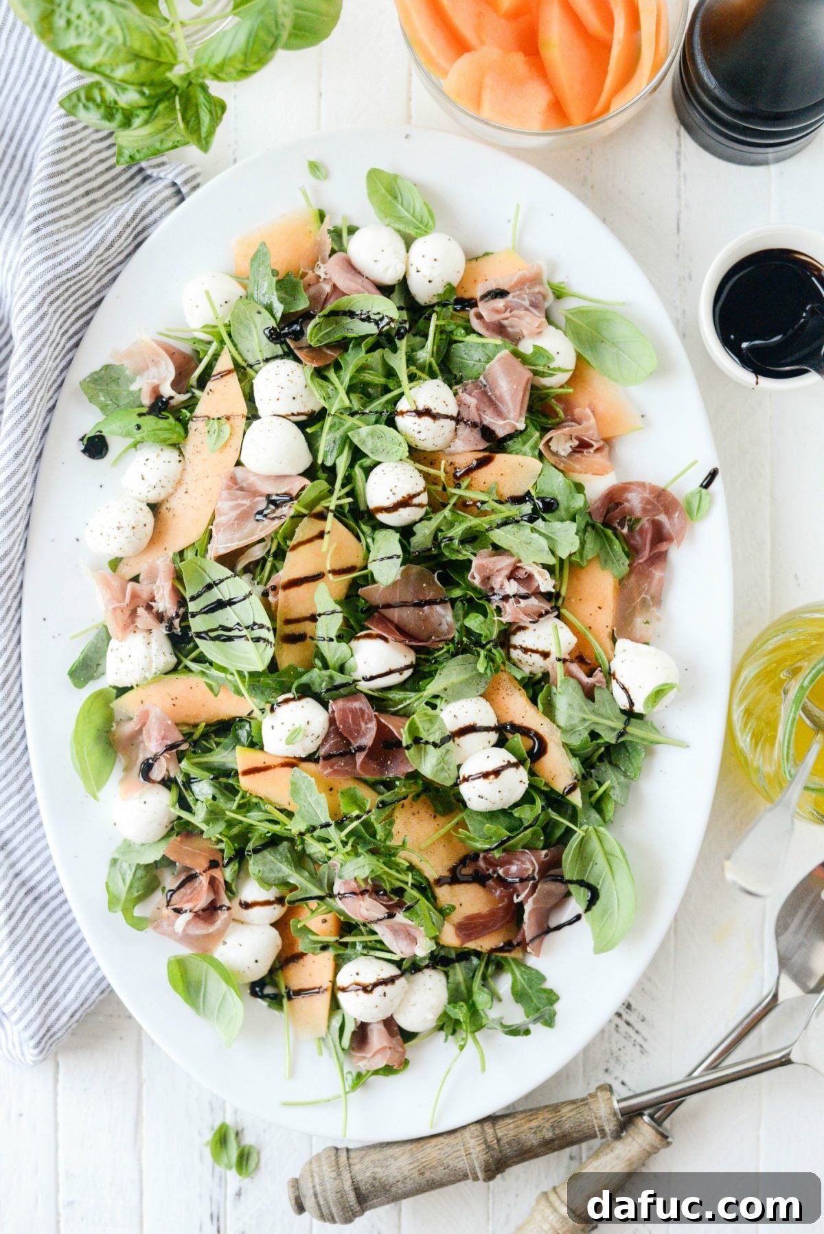 Golden Melon Prosciutto Arugula Fresca 7 Lightly dressed baby arugula in a bowl, ready for assembly