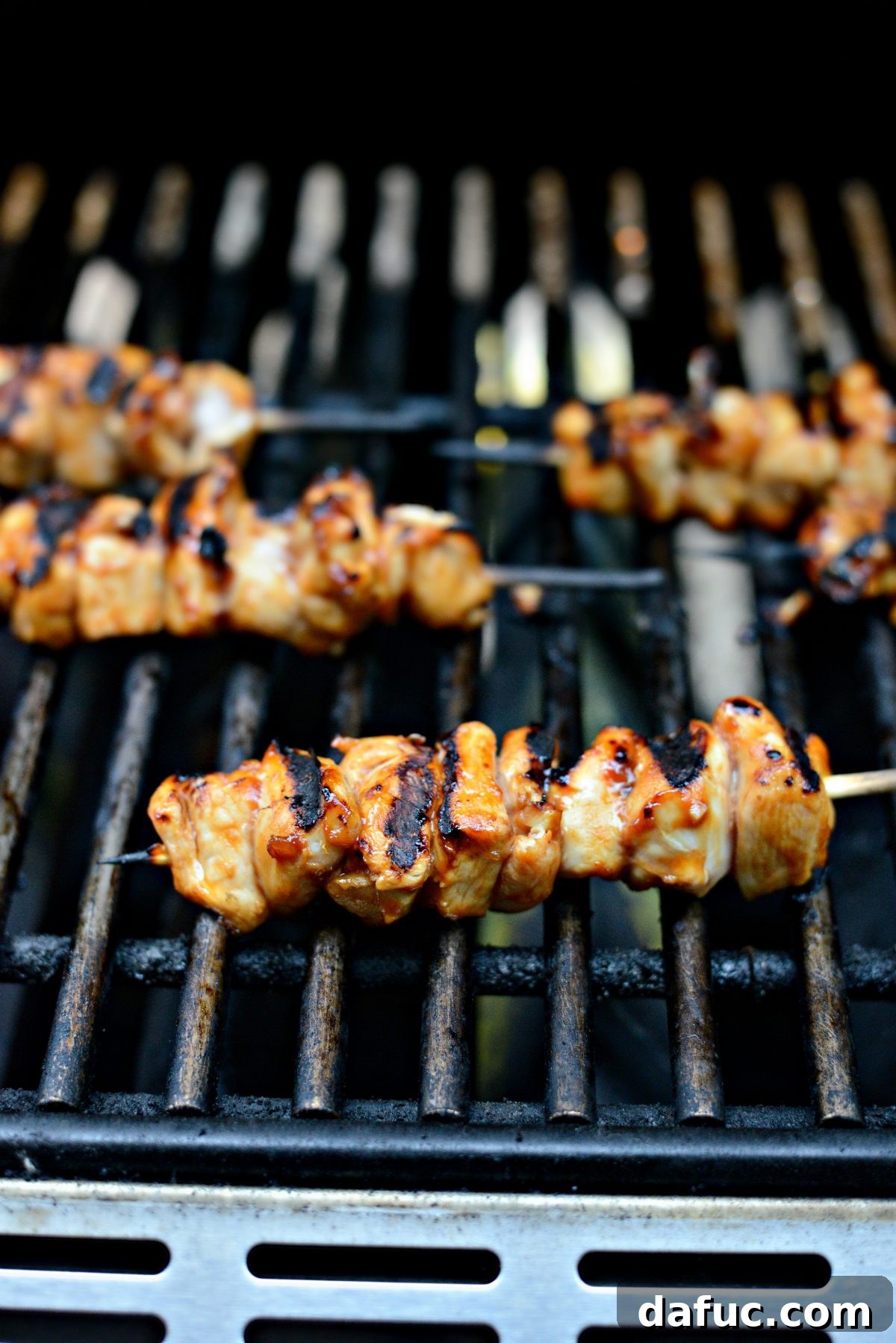grilled chicken skewers on grill.
