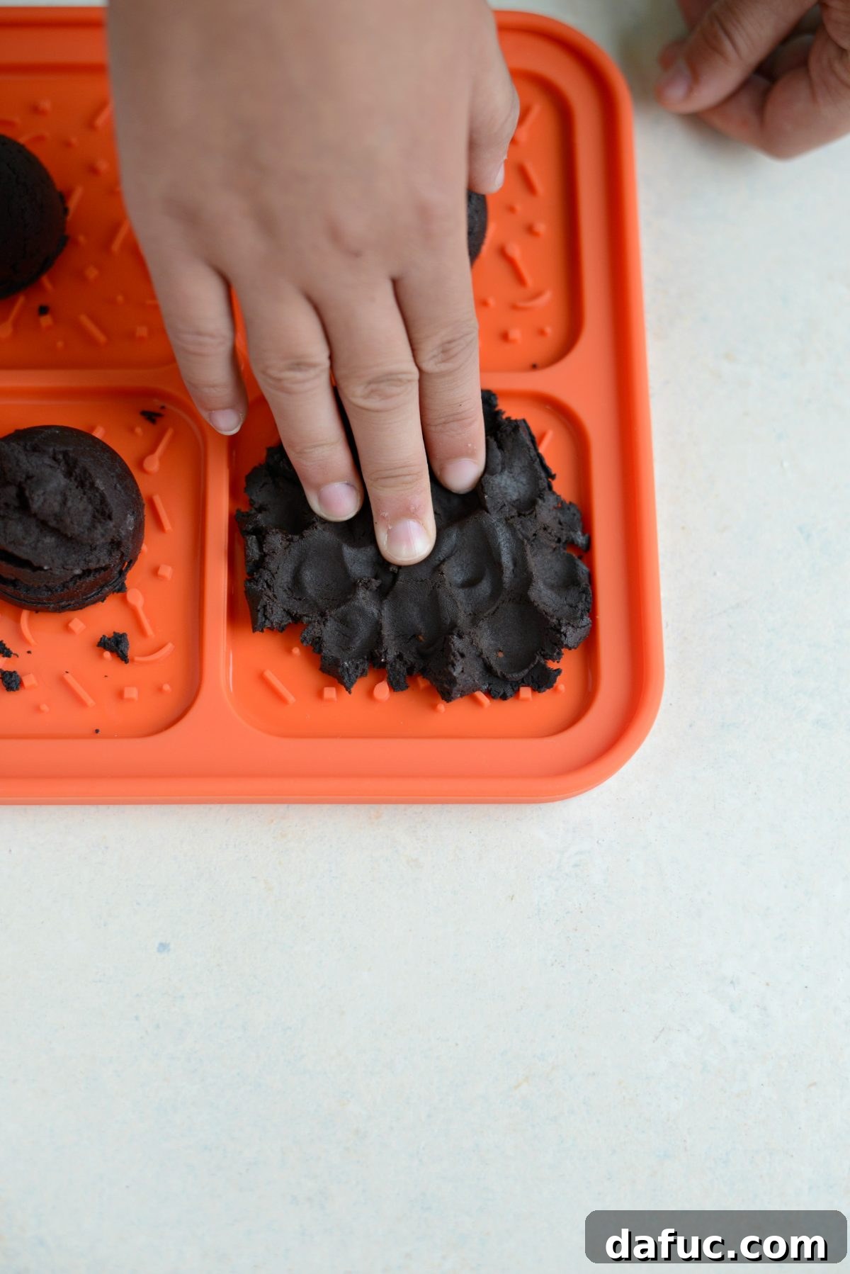 Pressing cookie dough into the mold